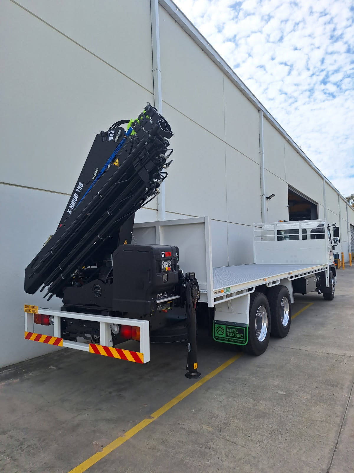 Hino crane truck with knuckle-boom crane and flat tray delivered to client