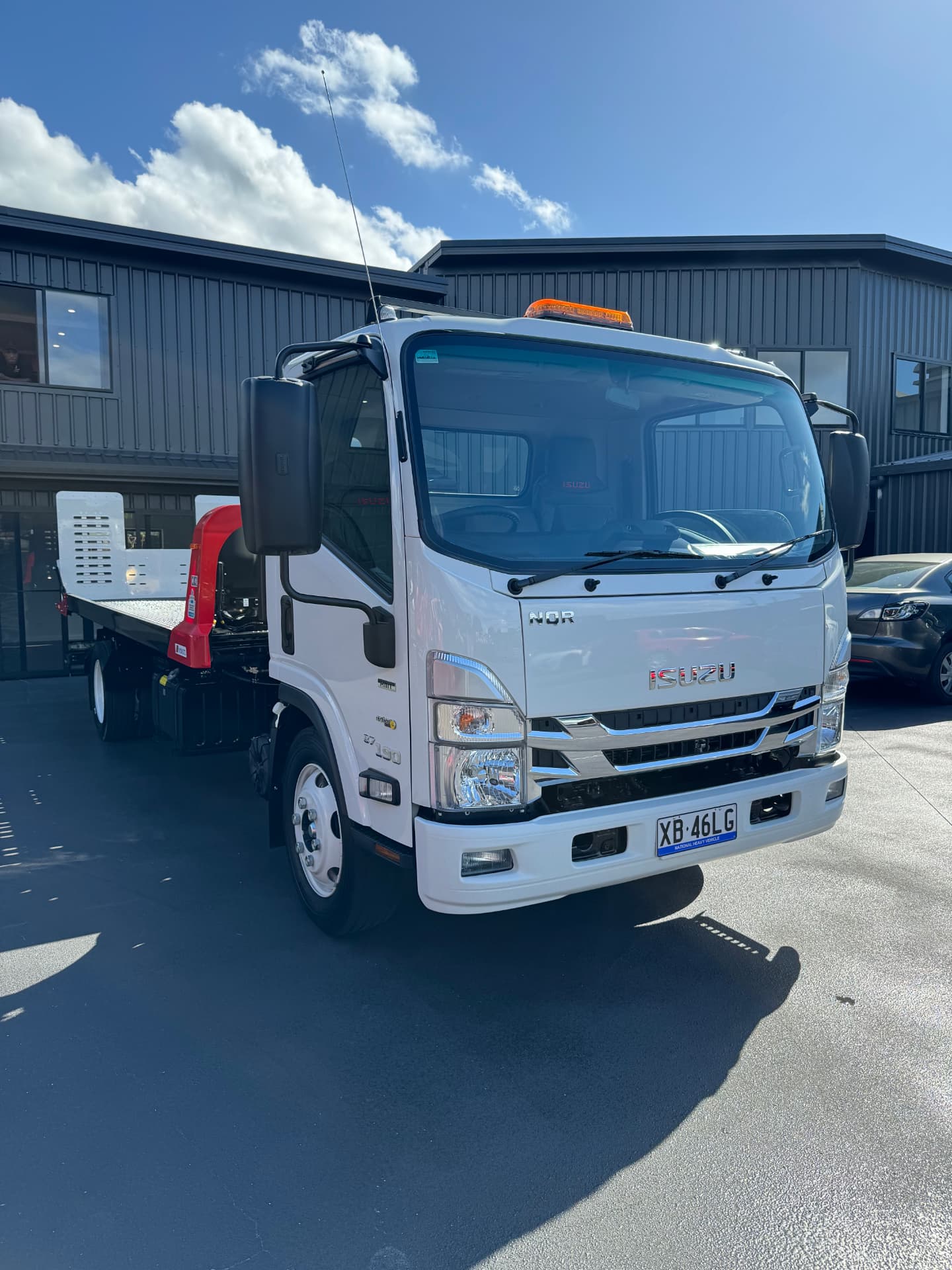 Isuzu NQR beavertail tilt tray truck delivered